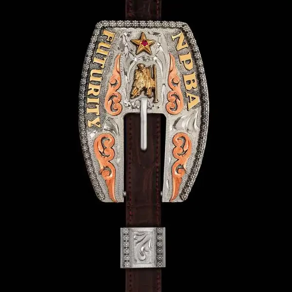 Our Oldenburg Headstall Buckle is hand crafted on a German Silver base, featuring a tri-metal design from the Copper scrolls to the Jeweler's Bronze figure, lettering and star emblem, accented with your choice of cubic zirconia stone color. Customize your